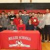 Kleeman with his teamates and Miller basketball coaches.